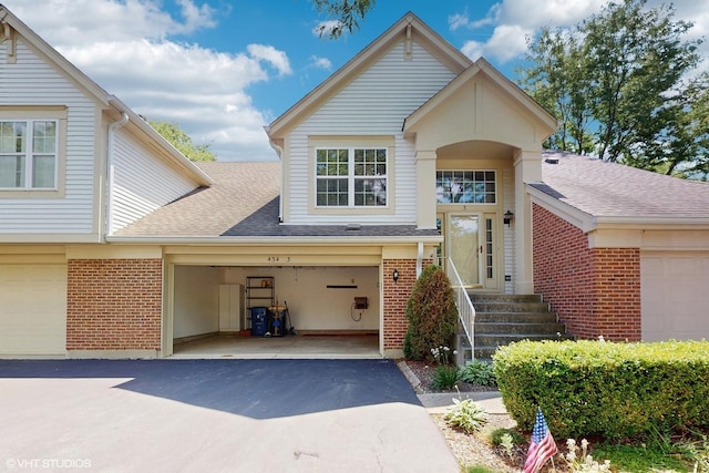 434 Cromwell Cir Unit 3, Bartlett, IL 60103 - view of front of property with brick siding, a garage, a shingled roof, and asphalt driveway