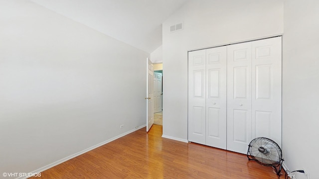 434 Cromwell Cir Unit 3, Bartlett, IL 60103 - unfurnished bedroom featuring light wood-type flooring, a closet, and high vaulted ceiling
