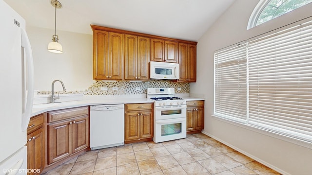 434 Cromwell Cir Unit 3, Bartlett, IL 60103 - kitchen featuring white appliances, backsplash, lofted ceiling, brown cabinetry, and hanging light fixtures