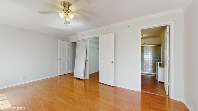 434 Cromwell Cir Unit 3, Bartlett, IL 60103 - unfurnished bedroom featuring crown molding, light wood-style floors, a spacious closet, and a ceiling fan