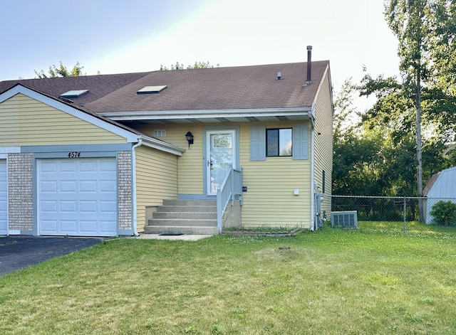 4574 Whitney Dr, Hanover Park, IL 60133 - view of front facade with a garage, entry steps, driveway, and a shingled roof