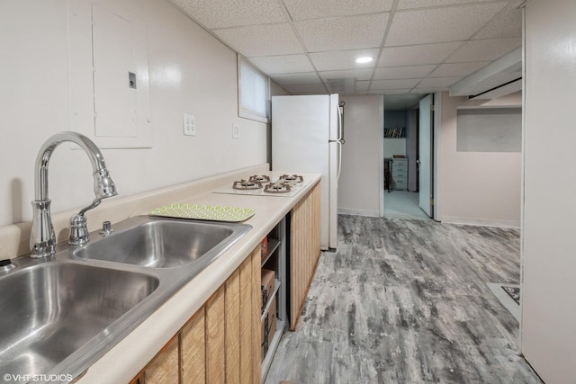 120 S Kinzie St, Thornton, IL 60476 - kitchen featuring freestanding refrigerator, light wood finished floors, brown cabinetry, light countertops, and a drop ceiling