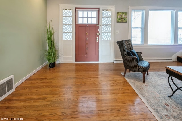 120 S Kinzie St, Thornton, IL 60476 - foyer entrance with wood finished floors, healthy amount of natural light, and a baseboard radiator