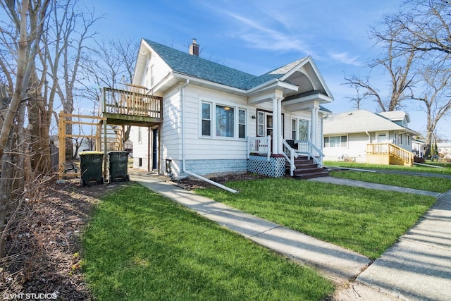 120 S Kinzie St, Thornton, IL 60476 - view of front of house with a chimney, roof with shingles, a front yard, and a deck