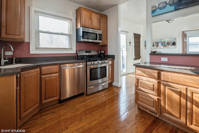 120 S Kinzie St, Thornton, IL 60476 - kitchen with stainless steel appliances, dark wood finished floors, dark countertops, and brown cabinetry