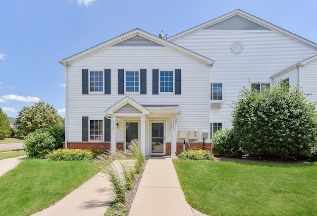 128 Bertram Dr Unit M, Yorkville, IL 60560 - view of front of property featuring brick siding and a front yard