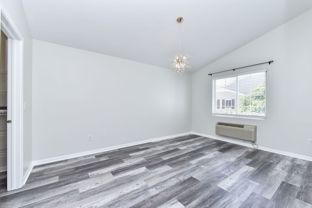 128 Bertram Dr Unit M, Yorkville, IL 60560 - spare room featuring a chandelier, dark wood finished floors, lofted ceiling, and a wall mounted AC