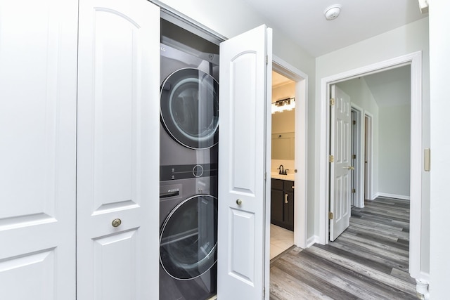 128 Bertram Dr Unit M, Yorkville, IL 60560 - washroom with stacked washer / drying machine and light wood finished floors