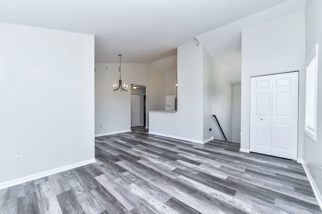 128 Bertram Dr Unit M, Yorkville, IL 60560 - unfurnished living room with a chandelier, wood finished floors, and high vaulted ceiling
