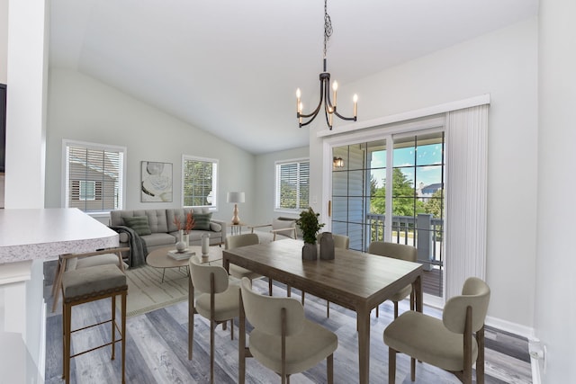 128 Bertram Dr Unit M, Yorkville, IL 60560 - dining space with wood finished floors, lofted ceiling, and a chandelier