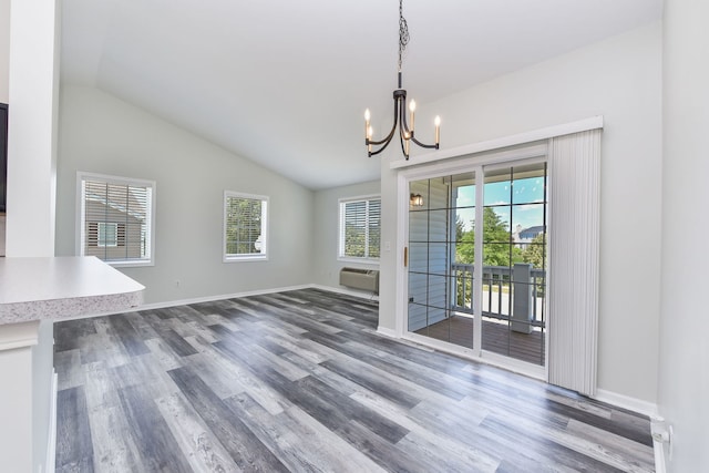 128 Bertram Dr Unit M, Yorkville, IL 60560 - unfurnished dining area with a chandelier, lofted ceiling, wood finished floors, and a wall unit AC