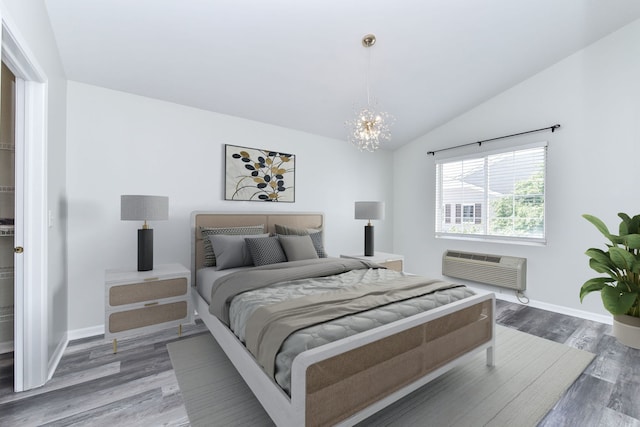 128 Bertram Dr Unit M, Yorkville, IL 60560 - bedroom with a chandelier, wood finished floors, lofted ceiling, and an AC wall unit