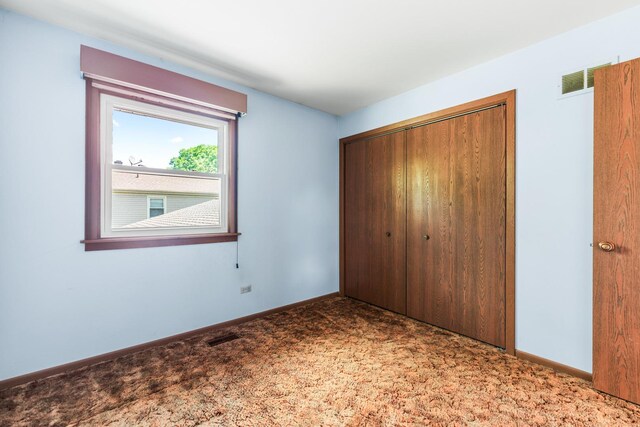 1707 Roosa Ln, Elk Grove Village, IL 60007 - unfurnished bedroom featuring a closet and carpet floors