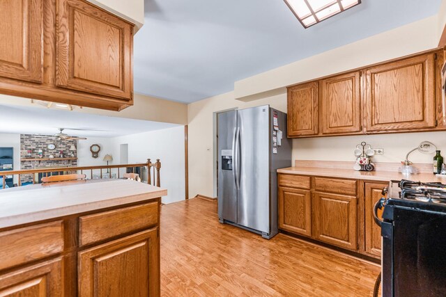 1707 Roosa Ln, Elk Grove Village, IL 60007 - kitchen with stainless steel fridge, black range with gas cooktop, and brown cabinets