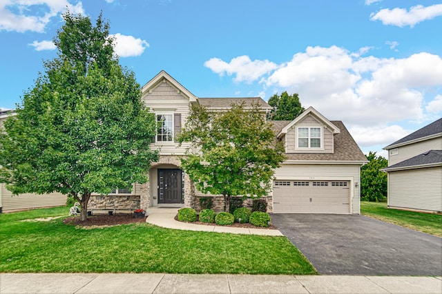 504 W Hillcrest Dr, Romeoville, IL 60446 - view of front facade with driveway, stone siding, a front lawn, an attached garage, and roof with shingles