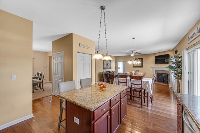 504 W Hillcrest Dr, Romeoville, IL 60446 - kitchen featuring open floor plan, a breakfast bar area, dark wood-type flooring, and dishwasher