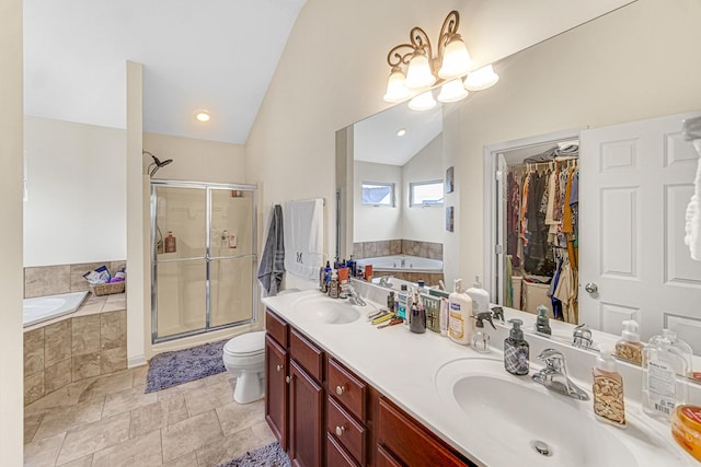 504 W Hillcrest Dr, Romeoville, IL 60446 - full bathroom with vaulted ceiling, a shower stall, double vanity, a garden tub, and a spacious closet