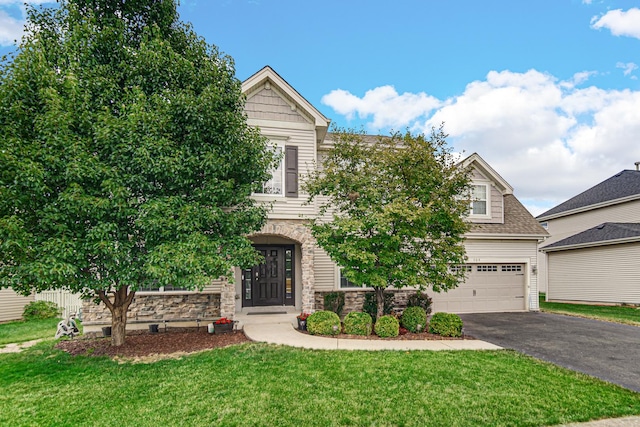 504 W Hillcrest Dr, Romeoville, IL 60446 - obstructed view of property with driveway, stone siding, a front yard, and an attached garage