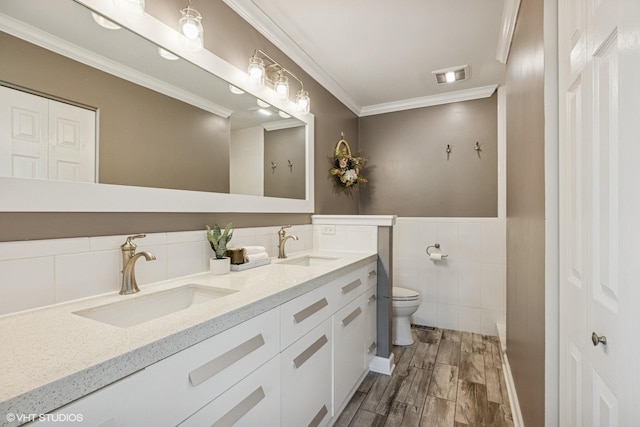 4315 Lombardy Ln, Hoffman Estates, IL 60192 - full bathroom featuring double vanity, wood finished floors, crown molding, tile walls, and wainscoting