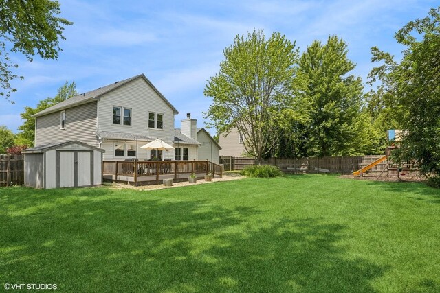 4315 Lombardy Ln, Hoffman Estates, IL 60192 - back of house featuring a fenced backyard, a storage shed, a deck, and a playground