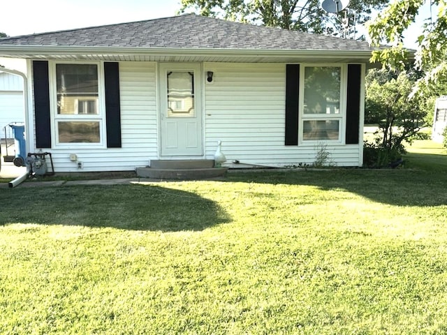 312 Water St, Earlville, IL 60518 - view of front facade with a front yard, entry steps, and roof with shingles