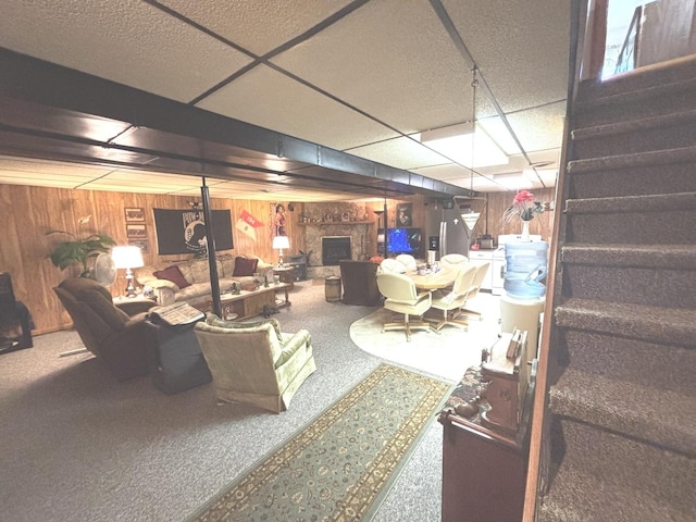 312 Water St, Earlville, IL 60518 - finished basement featuring stairway, carpet floors, a fireplace, wood walls, and a paneled ceiling