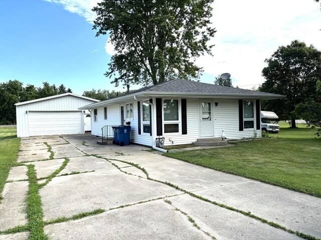 312 Water St, Earlville, IL 60518 - ranch-style house featuring an outdoor structure, a front lawn, and a garage