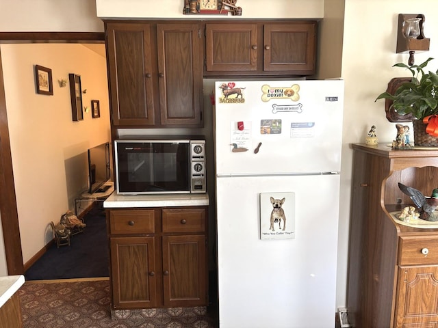 312 Water St, Earlville, IL 60518 - kitchen with freestanding refrigerator, black microwave, and light countertops