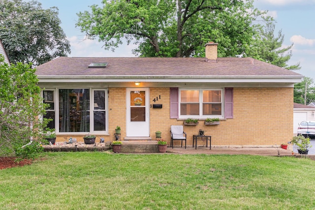 411 W Taylor Rd, Lombard, IL 60148 - ranch-style house with a front lawn, brick siding, a chimney, and roof with shingles