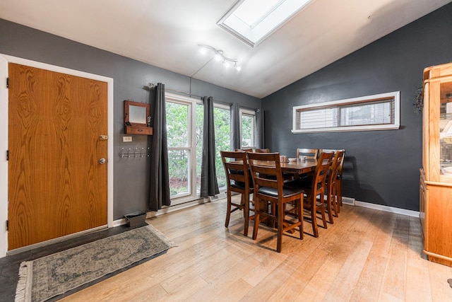 411 W Taylor Rd, Lombard, IL 60148 - dining area featuring vaulted ceiling, wood finished floors, and a skylight