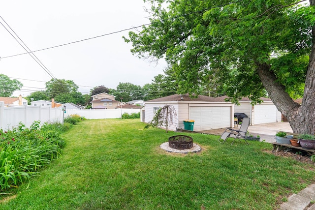 411 W Taylor Rd, Lombard, IL 60148 - view of yard with a detached garage, a fire pit, and an outbuilding
