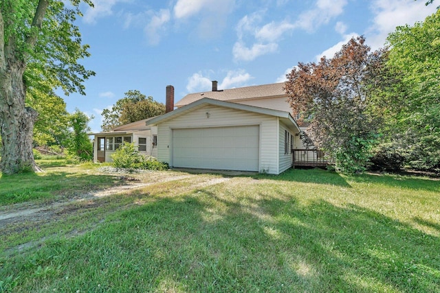 33049 S Symerton Rd, Wilmington, IL 60481 - view of side of property with a garage, a lawn, a chimney, a deck, and driveway
