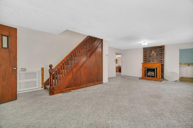 33049 S Symerton Rd, Wilmington, IL 60481 - unfurnished living room with stairs, a fireplace, and light carpet