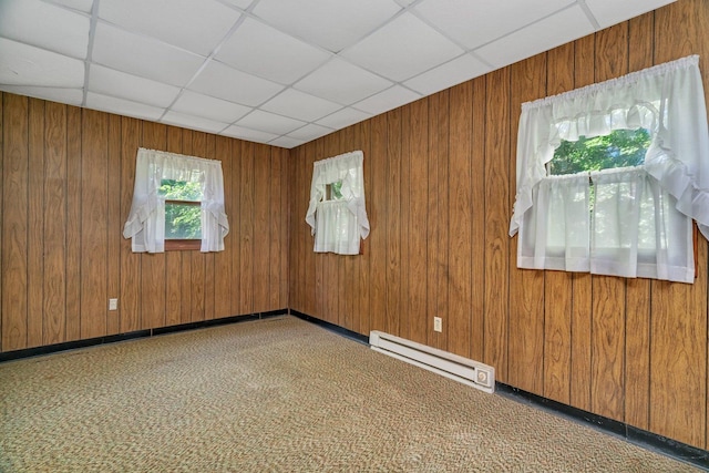 33049 S Symerton Rd, Wilmington, IL 60481 - carpeted spare room with a baseboard radiator, wooden walls, and a paneled ceiling