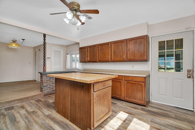 33049 S Symerton Rd, Wilmington, IL 60481 - kitchen with butcher block counters, light wood-style floors, ceiling fan, and a kitchen island