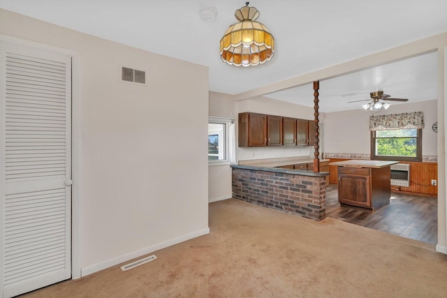 33049 S Symerton Rd, Wilmington, IL 60481 - kitchen featuring dark carpet, heating unit, a kitchen island, a ceiling fan, and light countertops