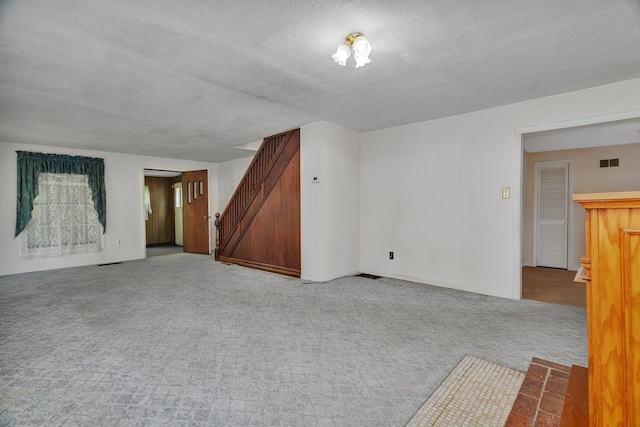 33049 S Symerton Rd, Wilmington, IL 60481 - unfurnished room featuring stairs, carpet, and a textured ceiling