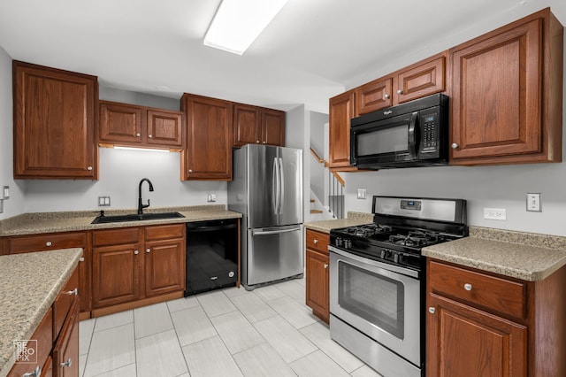36665 N Traer Ter, Gurnee, IL 60031 - kitchen featuring black appliances, brown cabinetry, and light countertops