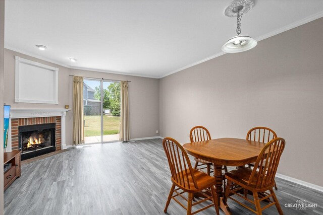 1517 Stoneridge Ct, Yorkville, IL 60560 - dining room with crown molding, wood finished floors, and a brick fireplace