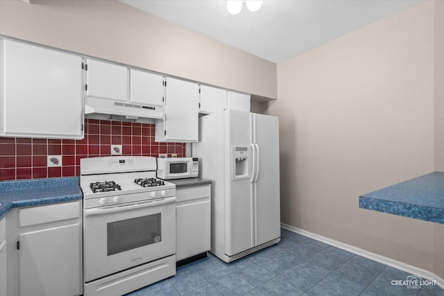 1517 Stoneridge Ct, Yorkville, IL 60560 - kitchen featuring white appliances, under cabinet range hood, white cabinets, and decorative backsplash