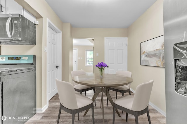 9613 S Yale Ave, Chicago, IL 60628 - dining space with washer / clothes dryer and light wood finished floors