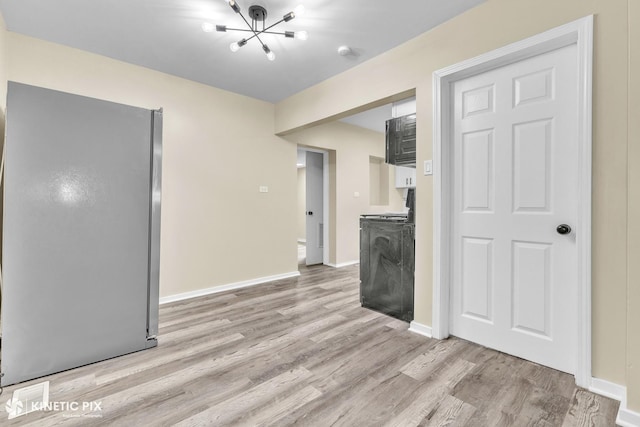 9613 S Yale Ave, Chicago, IL 60628 - unfurnished living room featuring light wood-type flooring and a chandelier