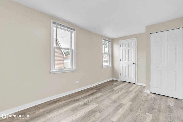 9613 S Yale Ave, Chicago, IL 60628 - unfurnished bedroom featuring light wood finished floors and a closet