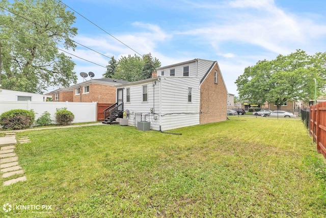 9613 S Yale Ave, Chicago, IL 60628 - back of house with a fenced backyard and brick siding