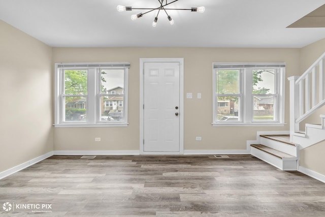 9613 S Yale Ave, Chicago, IL 60628 - entryway with stairs, a chandelier, plenty of natural light, and wood finished floors