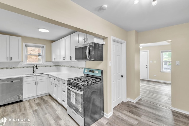 9613 S Yale Ave, Chicago, IL 60628 - kitchen with stainless steel appliances, tasteful backsplash, light wood-type flooring, and healthy amount of natural light
