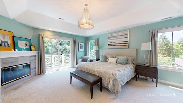 905 Burnham Ct, Aurora, IL 60502 - bedroom featuring access to outside, carpet floors, a fireplace with flush hearth, and a tray ceiling
