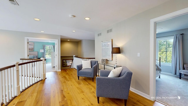905 Burnham Ct, Aurora, IL 60502 - sitting room with an upstairs landing, light wood finished floors, and recessed lighting