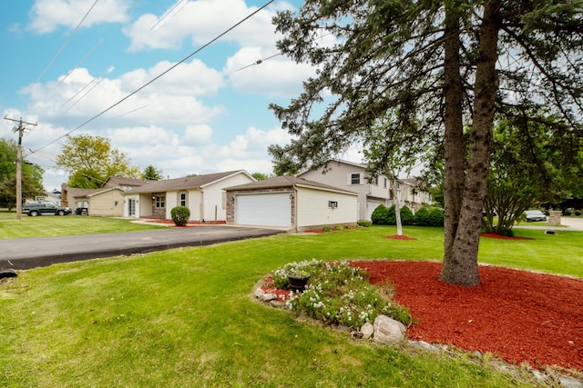 712 Mchenry Ave, Mchenry, IL 60050 - view of front of property featuring asphalt driveway, a front yard, and an attached garage