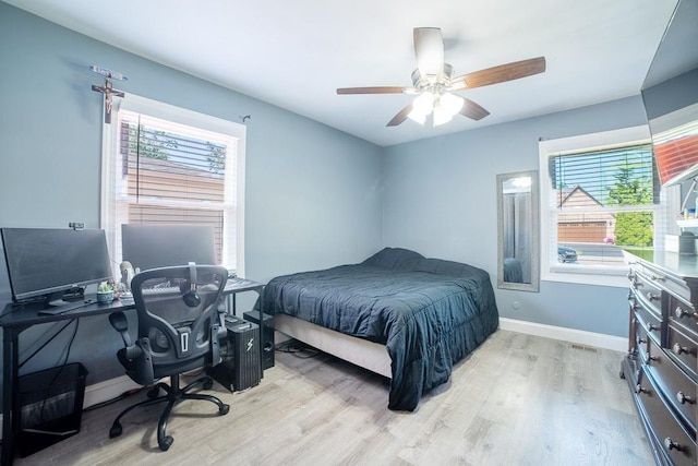 712 Mchenry Ave, Mchenry, IL 60050 - bedroom with light wood-type flooring, a desk, and ceiling fan